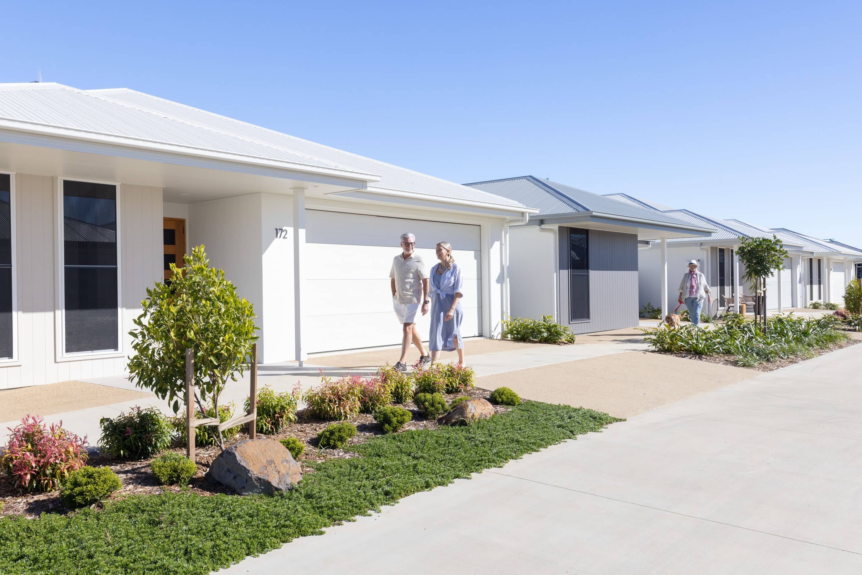A couple walk down the street holding hands