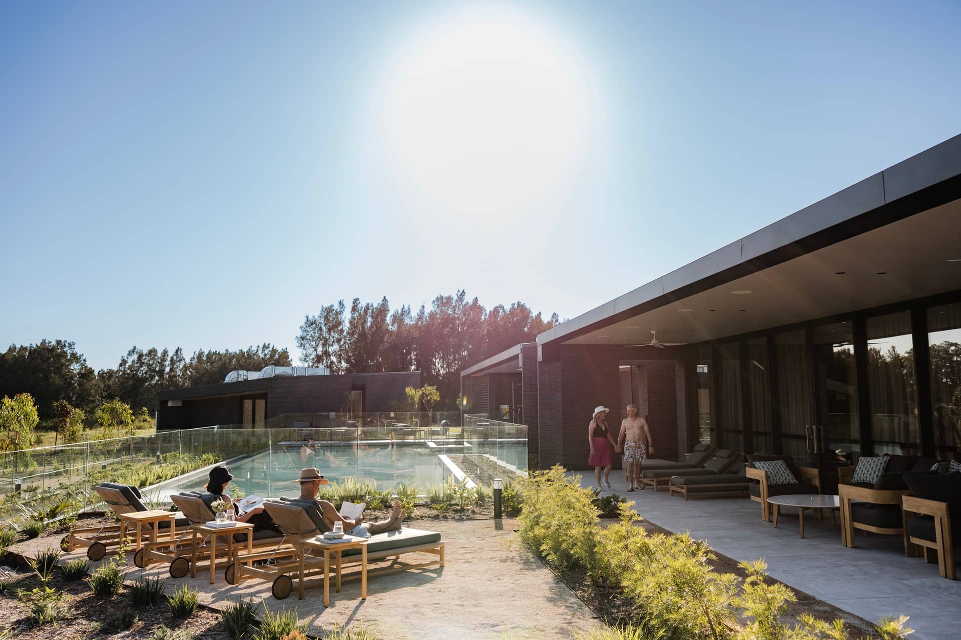 People relaxing by a resort-style pool at an Ingenia Lifestyle community.