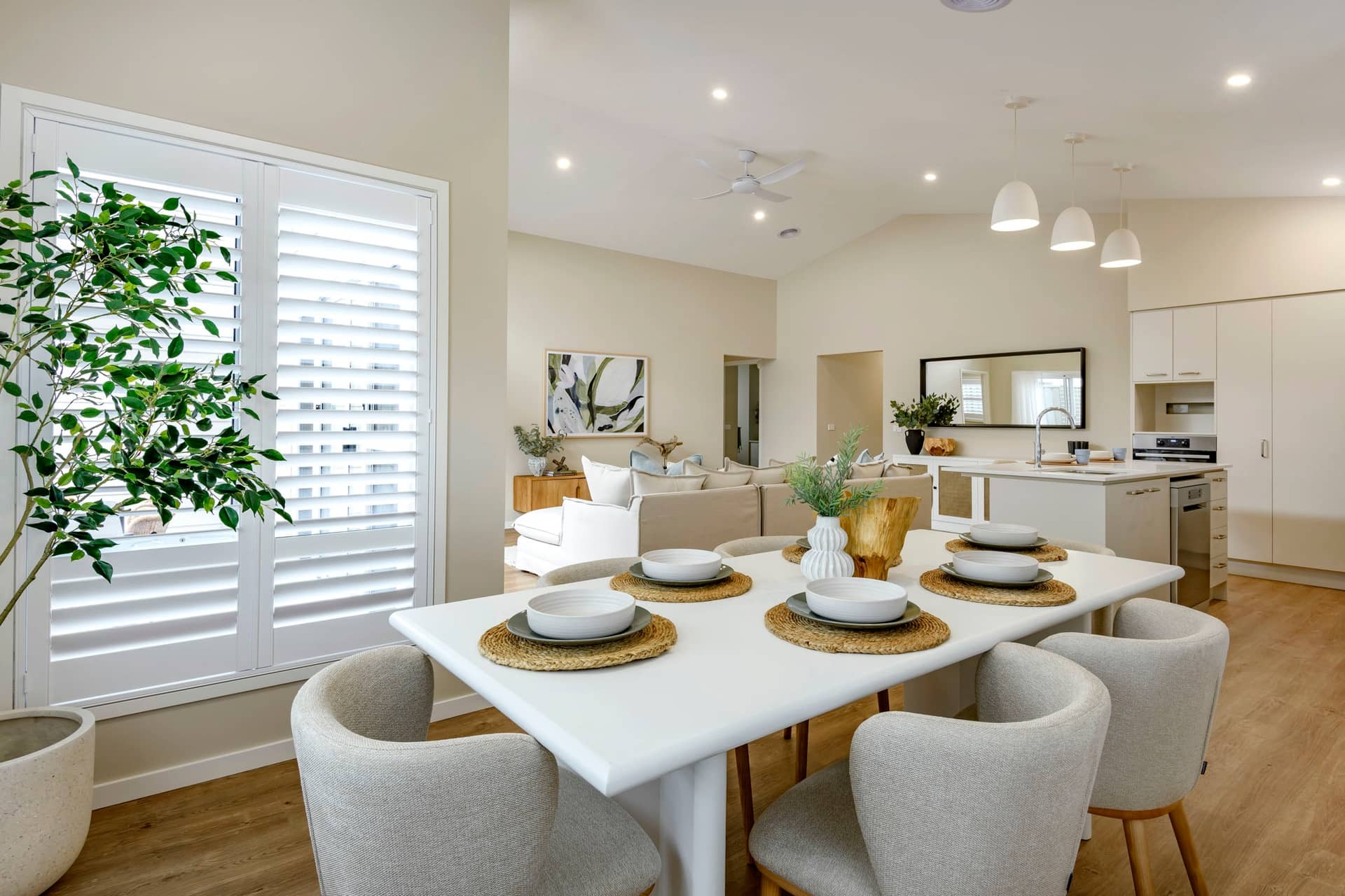 Dining area in an Ingenia Lifestyle community home with a white table, chairs, and open-plan living space.