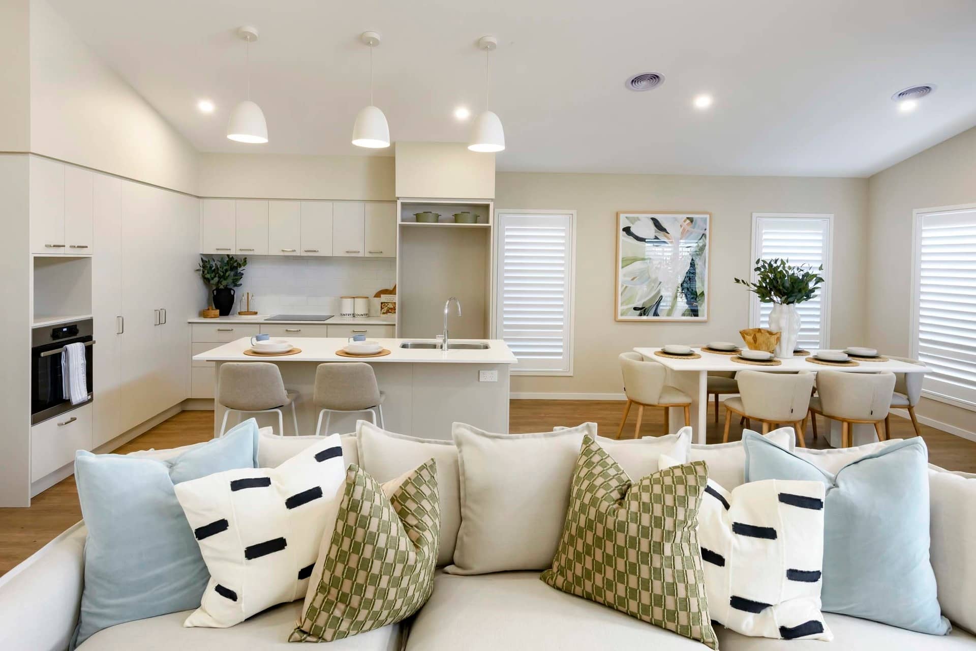 Modern open-plan living area with kitchen, dining, and lounge in an Ingenia Lifestyle community.