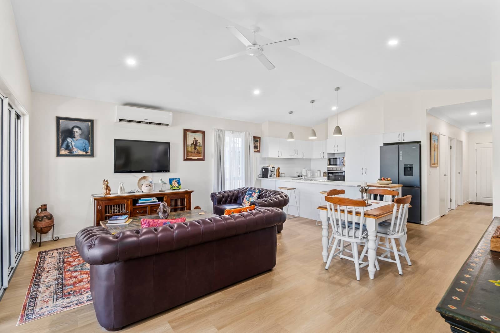 Living room and kitchen area in an Ingenia Lifestyle community home, featuring a TV, lounge, and dining area.