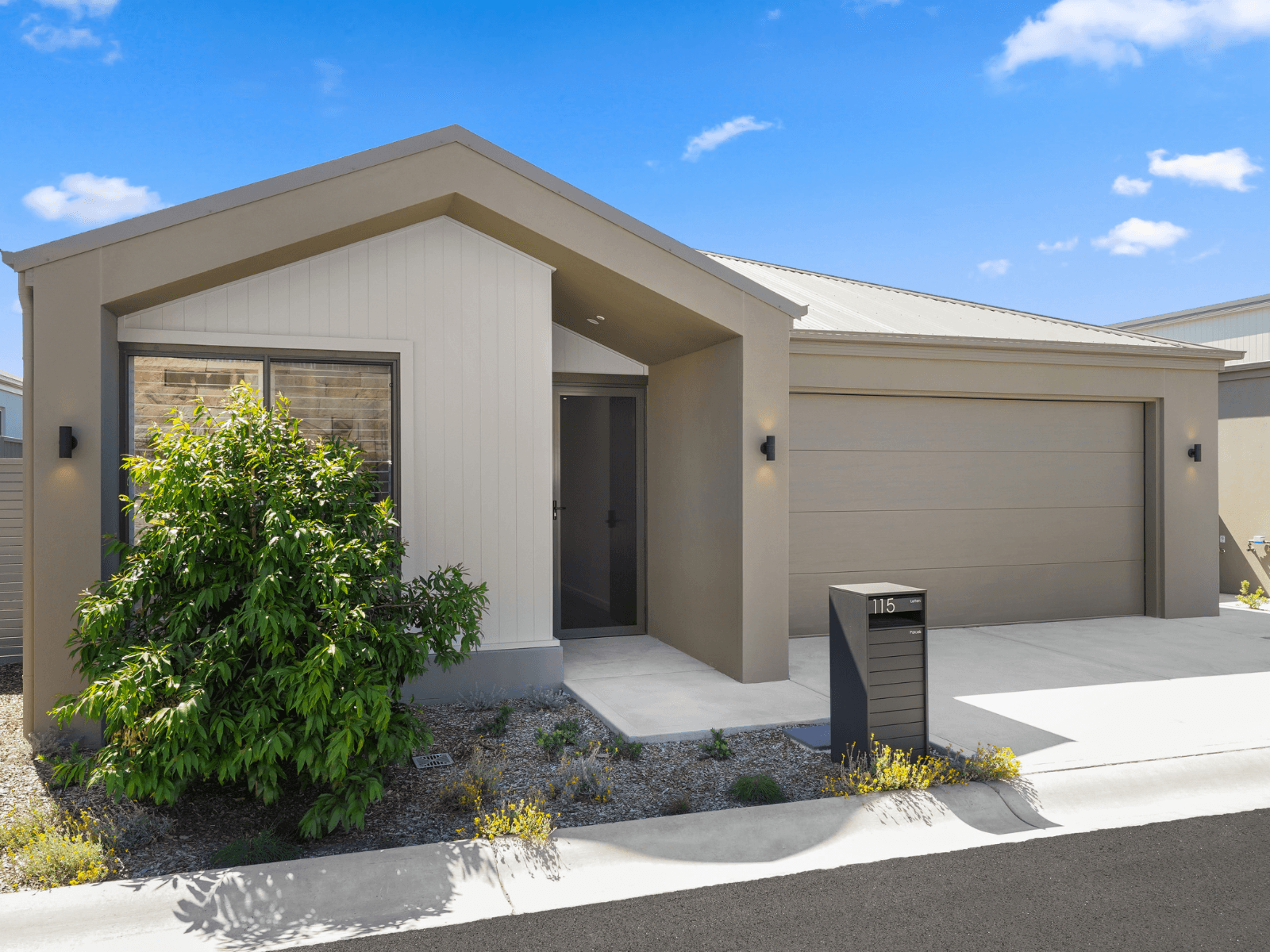 Modern Ingenia Lifestyle home with neutral-toned exterior, double garage, and low-maintenance landscaping.