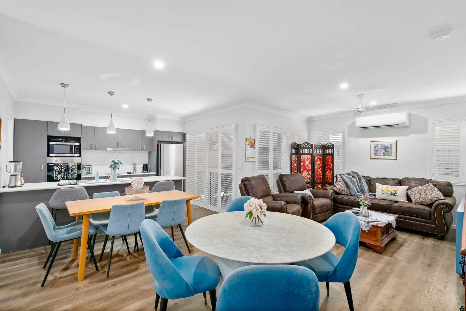 Open-plan living area with kitchen, dining, and lounge spaces in an Ingenia Lifestyle community.