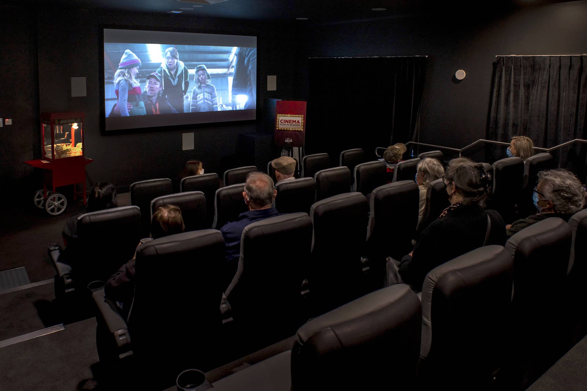 People watch a movie in a community cinema at an Ingenia Lifestyle community.