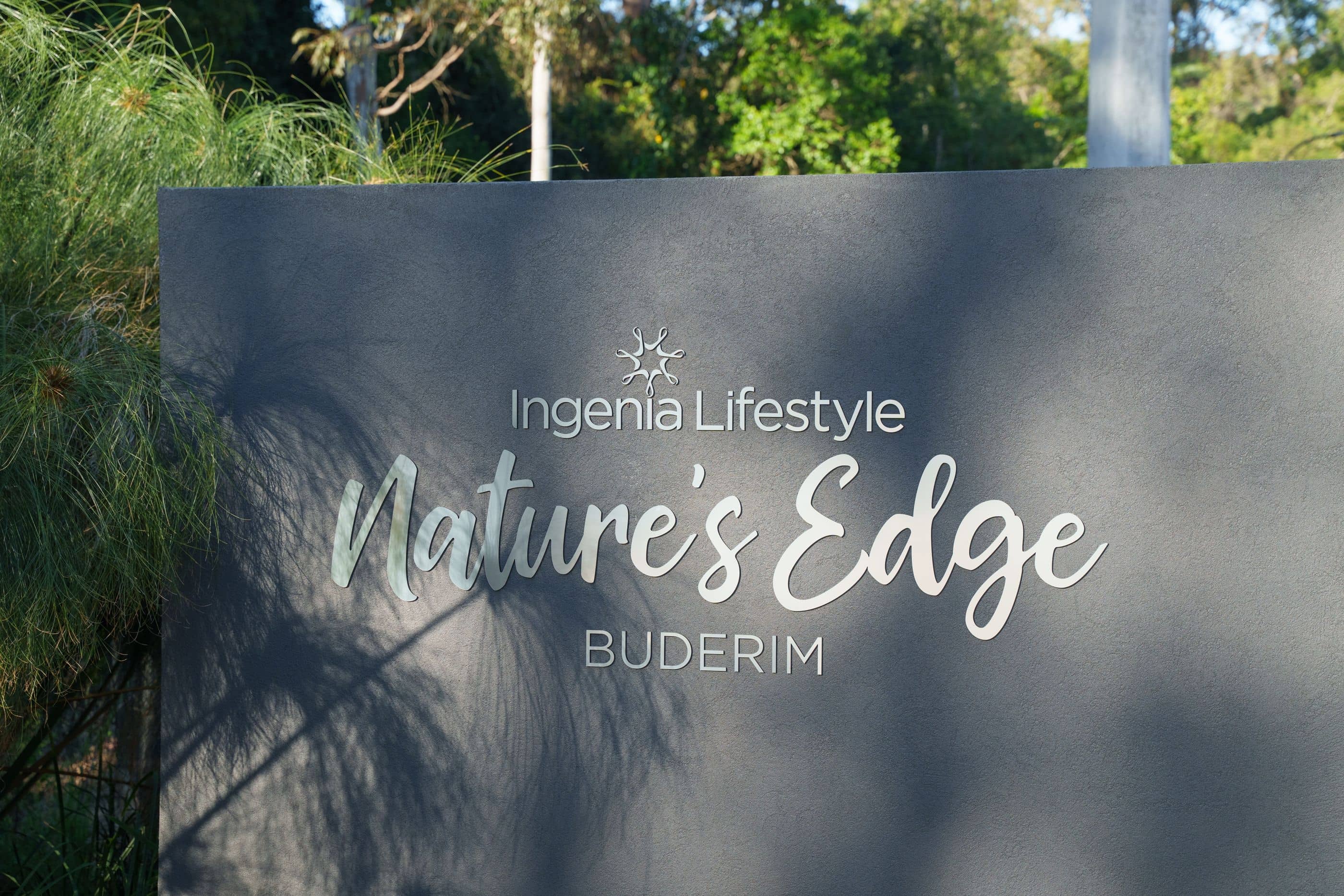 Entrance sign for Ingenia Lifestyle Nature's Edge Buderim community, with lush green landscaping.