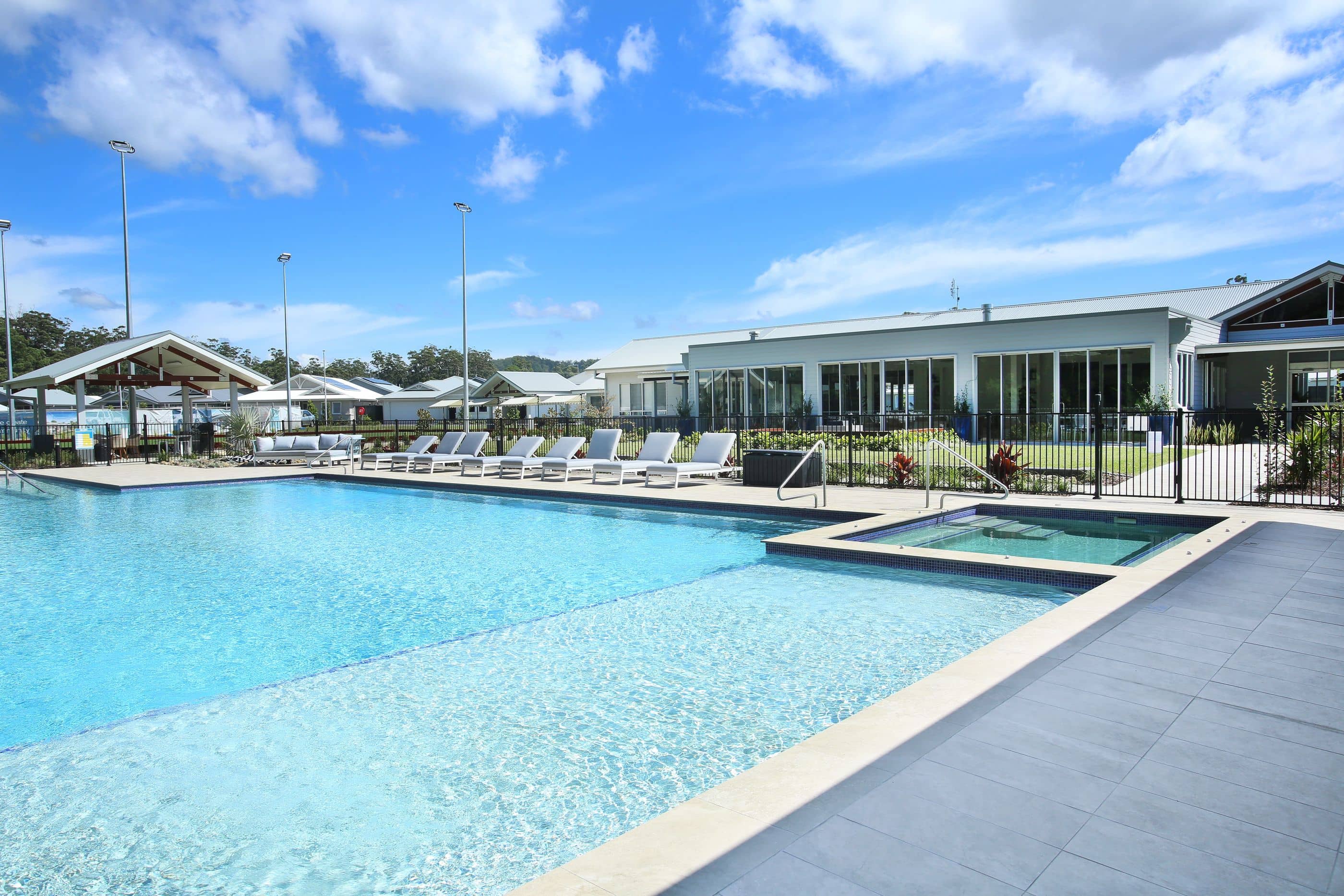 Ingenia Lifestyle community pool and spa area with sun lounges and covered pavilion.