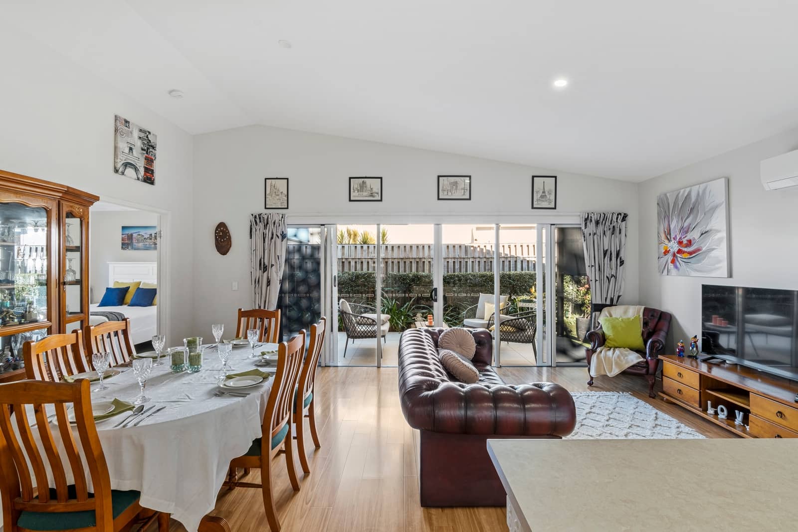 A spacious living and dining area in an Ingenia Lifestyle home with a large dining table and leather lounge.