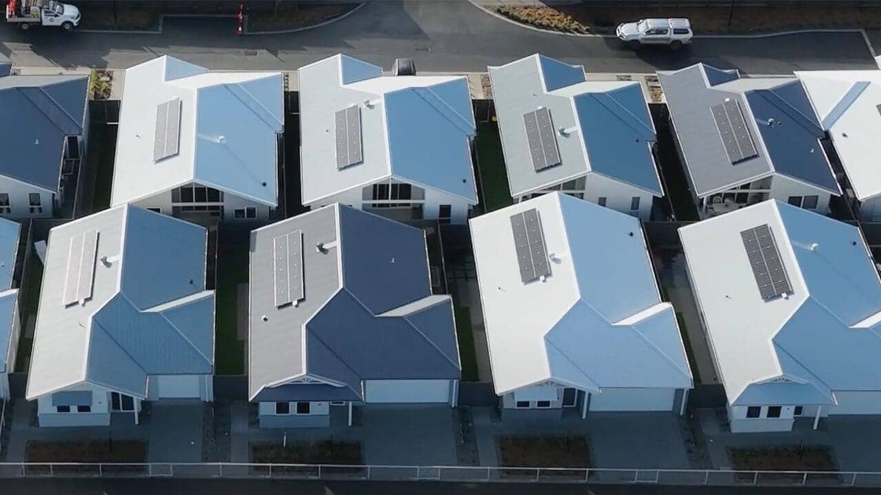 Aerial view of a modern Ingenia Lifestyle community with multiple homes featuring solar panels.