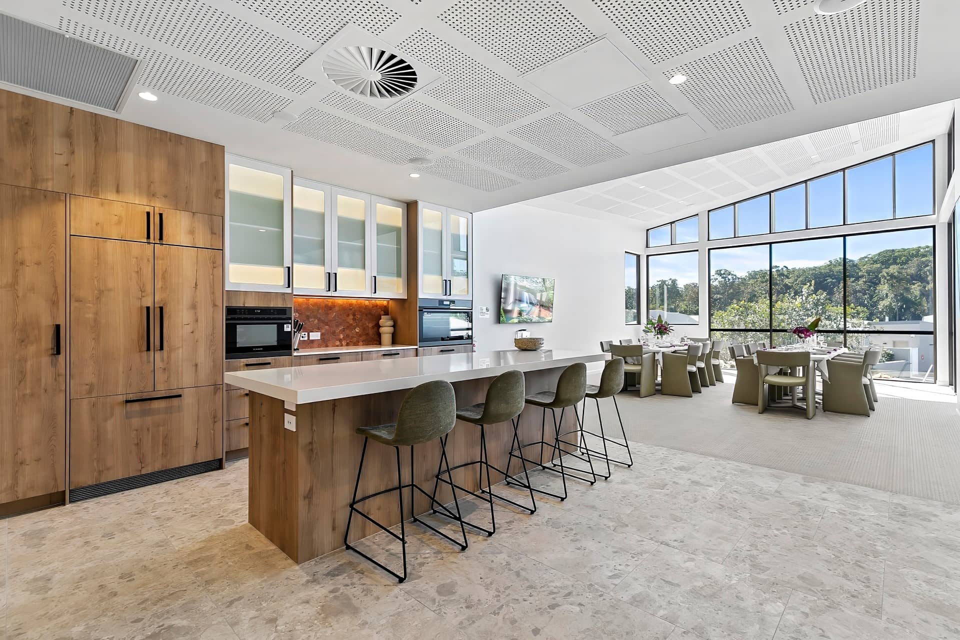 Bright, modern shared kitchen with island seating and an adjoining dining area, typical of Ingenia Lifestyle community amenities.