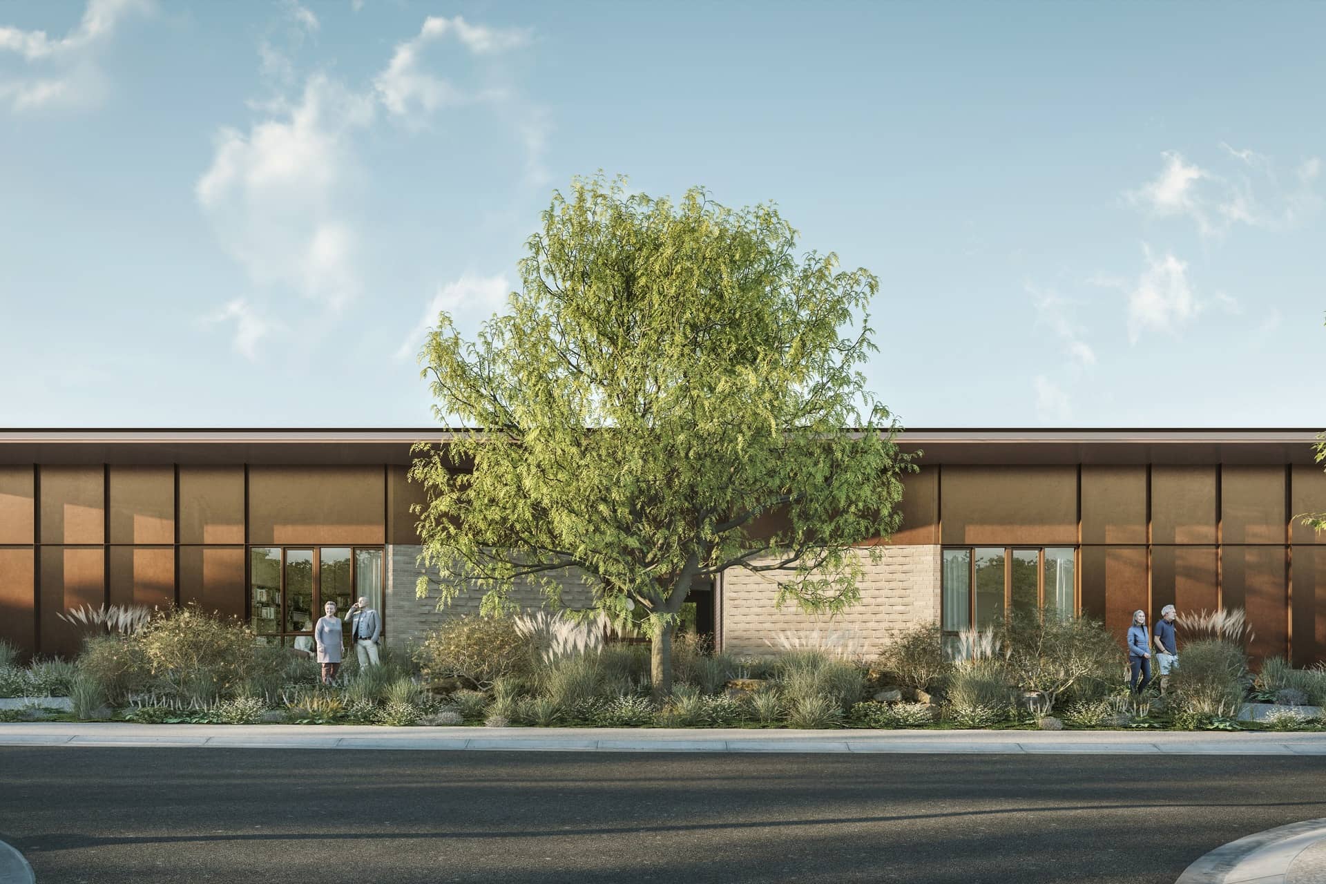 Modern Ingenia Lifestyle community building with bronze cladding, stone accents, extensive landscaping, and people outside.