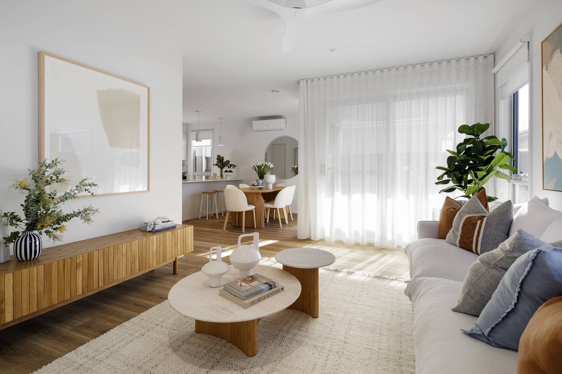 Bright open-plan living, dining, and kitchen area within an Ingenia Lifestyle home, with modern furnishings and decor.