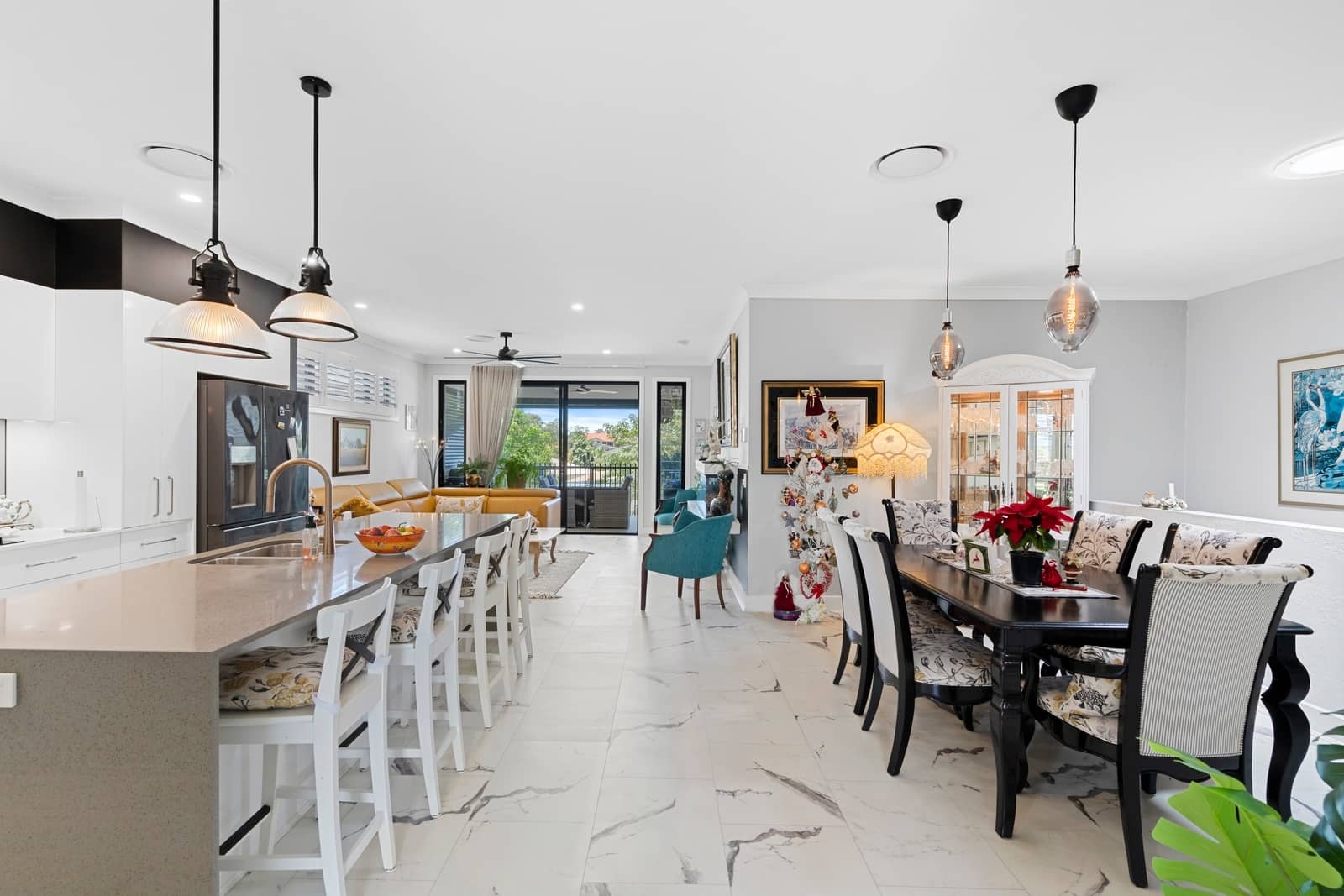 Open plan living area with kitchen island, dining table, and lounge in an Ingenia Lifestyle community.