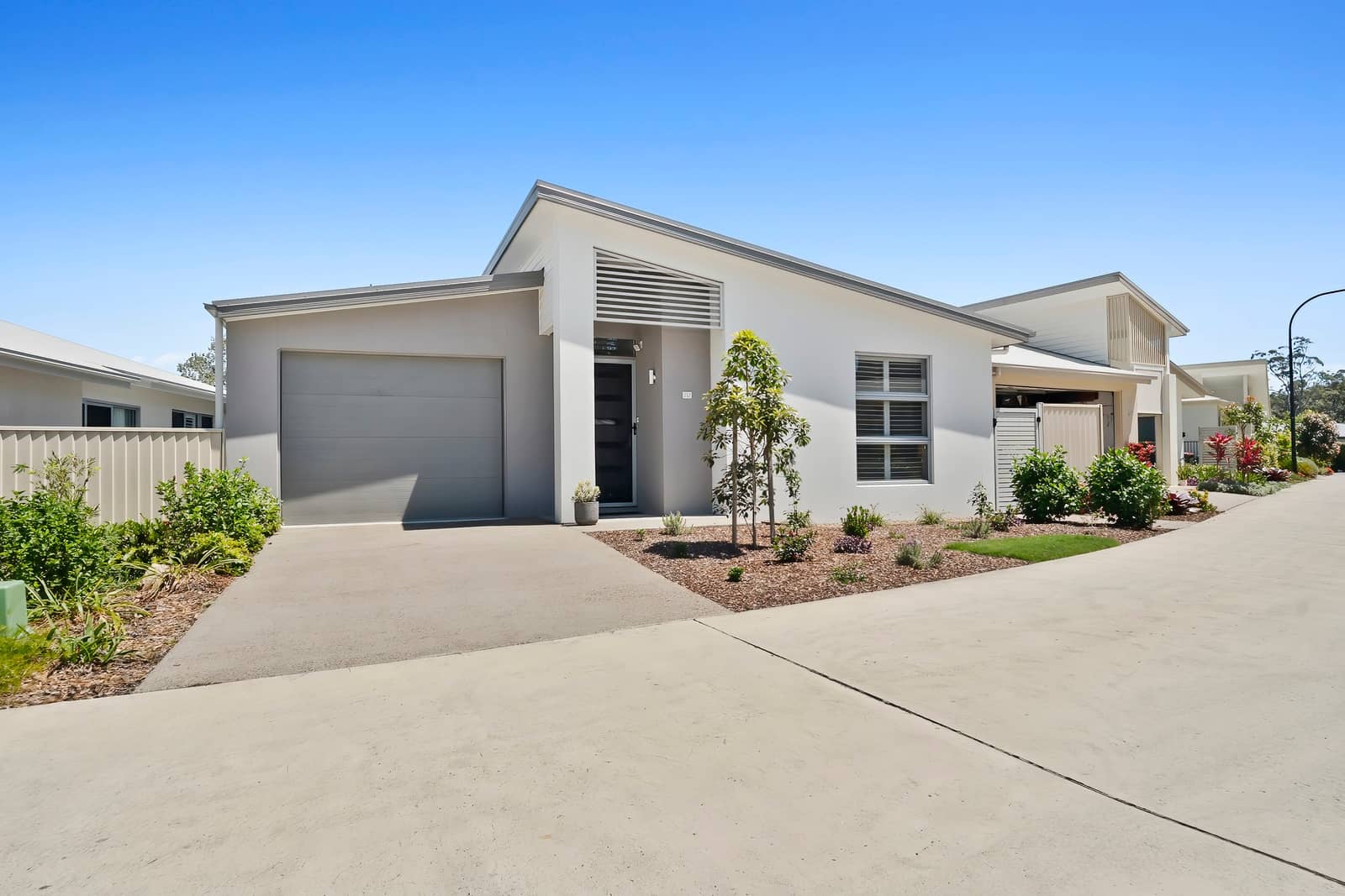 Modern land lease home at an Ingenia Lifestyle community, with garage, landscaped front garden, and driveway.
