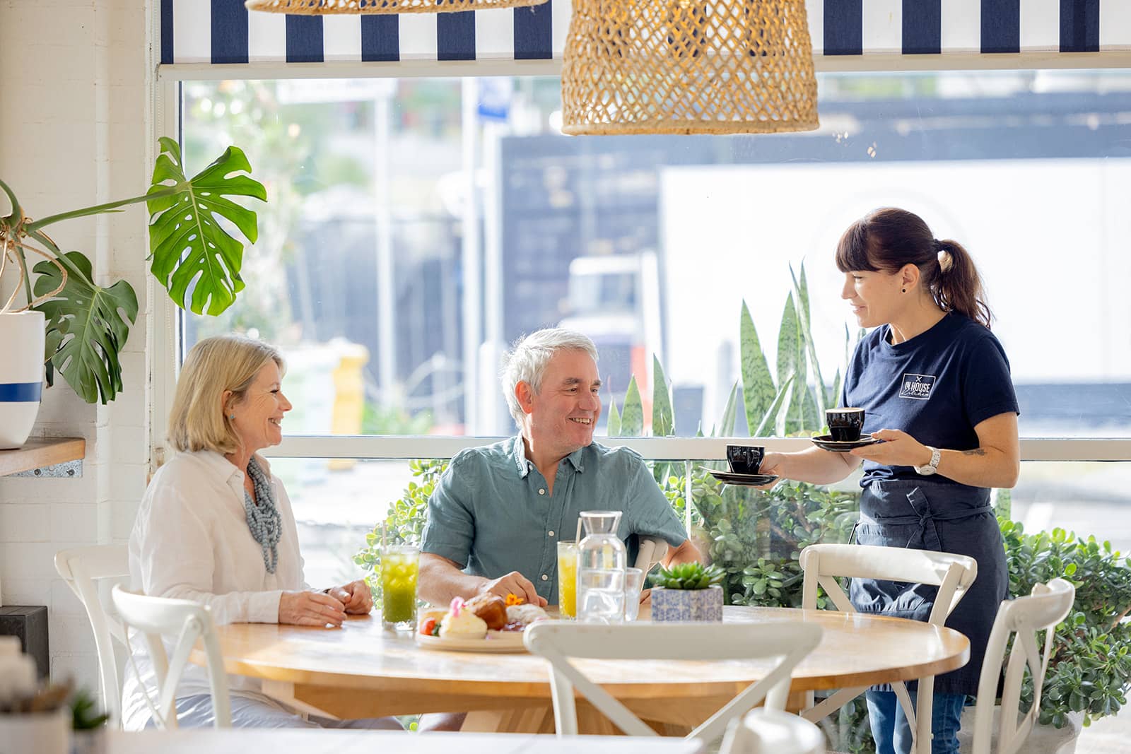 Two people in a cafe drinking coffee