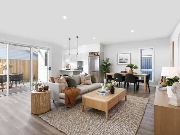 Open-plan living, dining, and kitchen area in an Ingenia Lifestyle home, featuring modern decor and outdoor patio access.