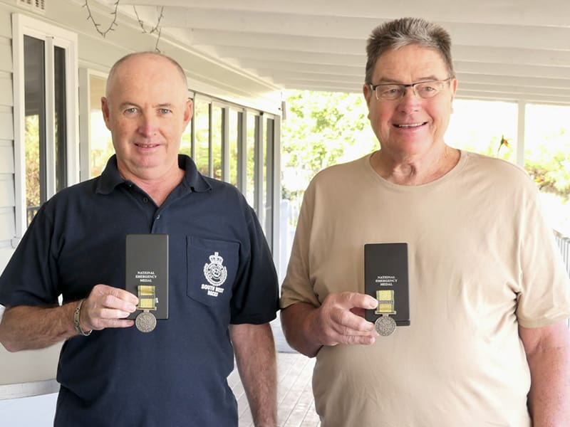 Geoff and Ron receiving their medals