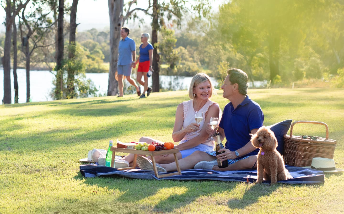 Ingenia Lifestyle Seachange Riverside Coomera old-couple-with-a-dog-having-a-picnic